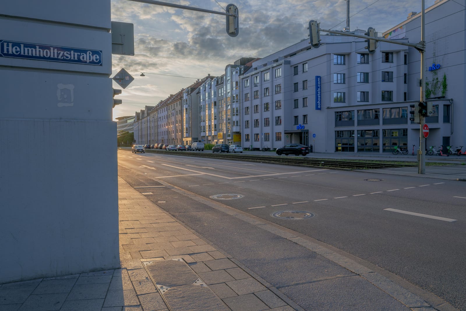 Helmholtzstraße street sign and an empty avenue at sunset.